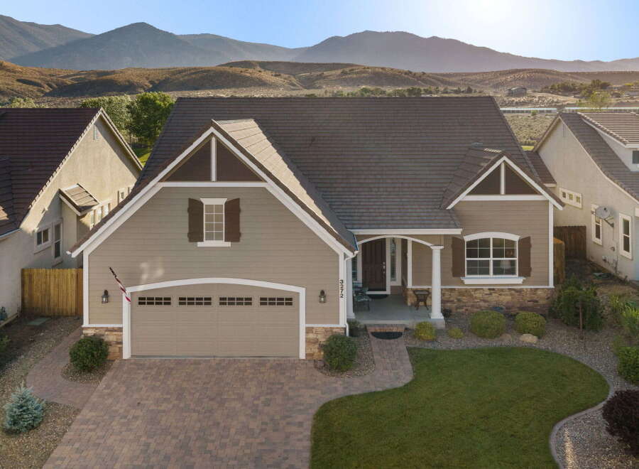 Discover this stunning home featuring a charming facade with stone accents and a welcoming covered porch.
