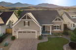 Discover this stunning home featuring a charming facade with stone accents and a welcoming covered porch.