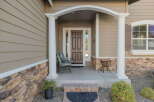 Welcome guests to this charming home with a covered front porch, perfect for enjoying your morning coffee.