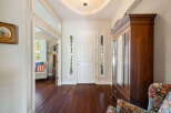 Step into this inviting entryway featuring a grand white door flanked by decorative sidelights.