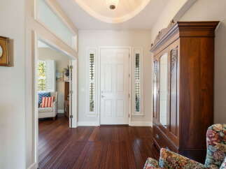Step into this inviting entryway featuring a grand white door flanked by decorative sidelights.