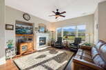 Experience breathtaking mountain views from this stunning living room, featuring a cozy fireplace and a large, ornate rug perfect for gathering.