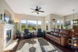Experience breathtaking mountain views from this stunning living room, featuring a cozy fireplace and comfortable leather seating.