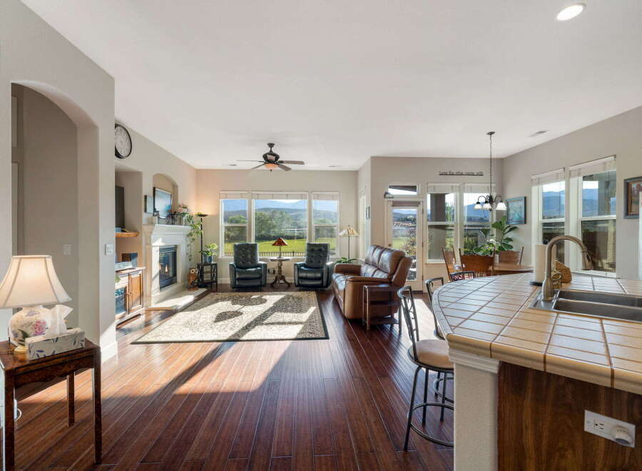 Experience breathtaking mountain views from this stunning living area, featuring a cozy fireplace and ample natural light.
