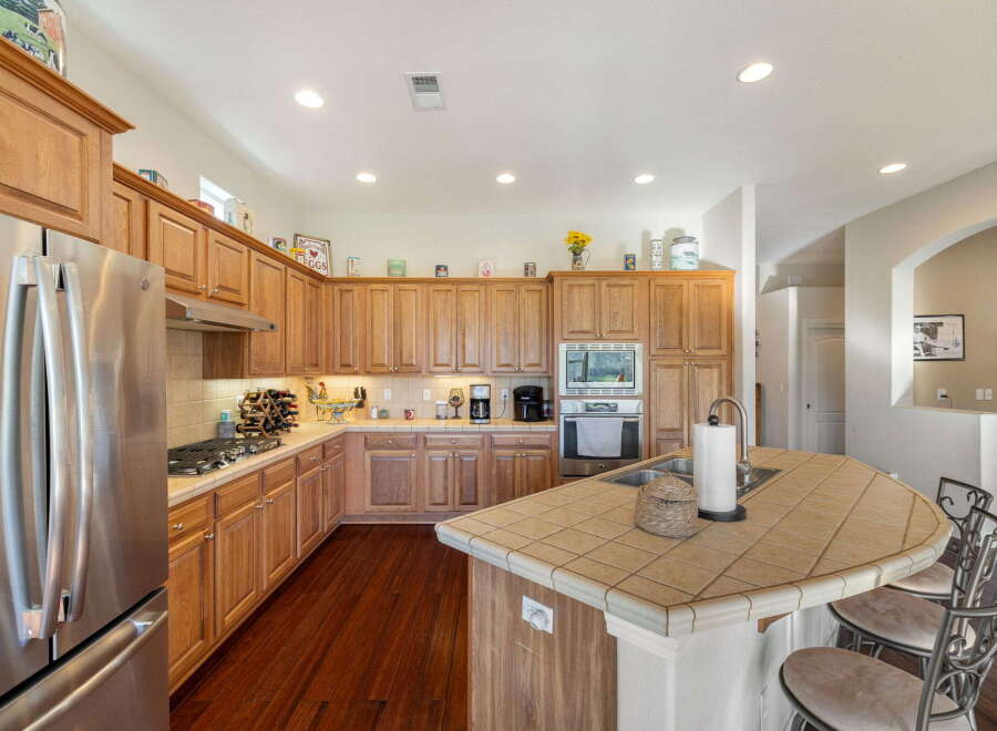 Discover this spacious kitchen featuring warm wood cabinetry and a large island perfect for entertaining.