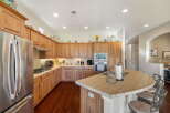 Discover this spacious kitchen featuring warm wood cabinetry and a large island perfect for entertaining.