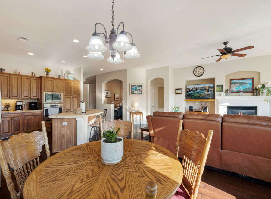 This spacious open-concept living area seamlessly blends a modern kitchen with a comfortable living room, perfect for entertaining.