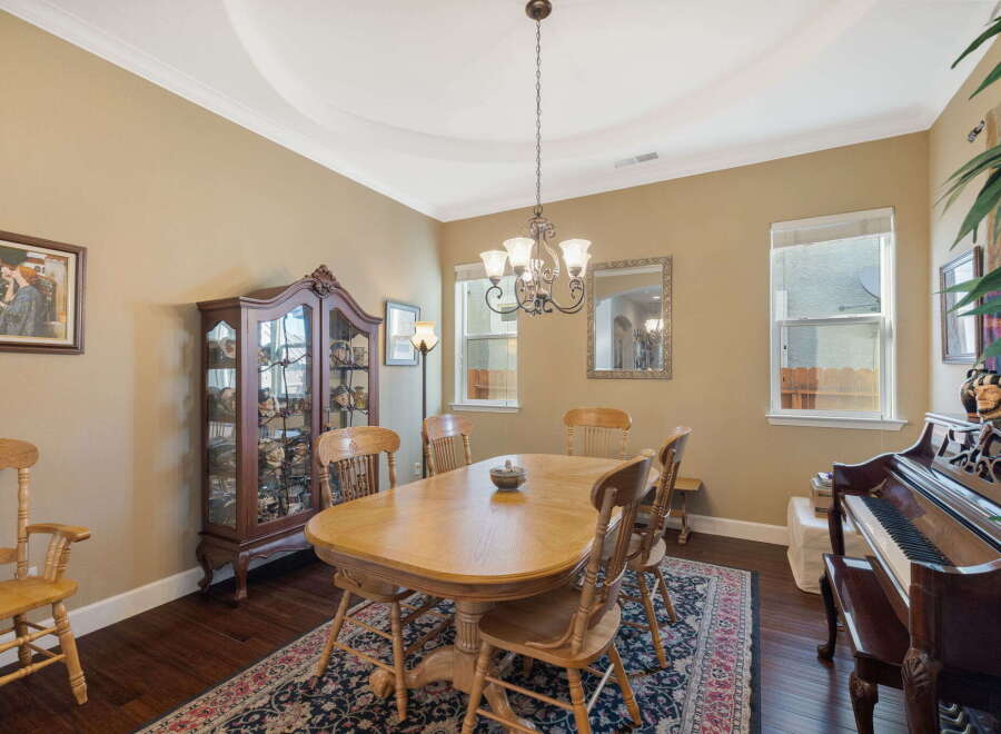 This elegant dining room features a classic wooden dining table with chairs, perfect for family gatherings.