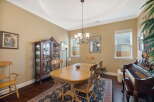 This elegant dining room features a classic wooden dining table with chairs, perfect for family gatherings.