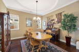 This elegant dining room features a large wooden dining table with six chairs, perfect for family gatherings.