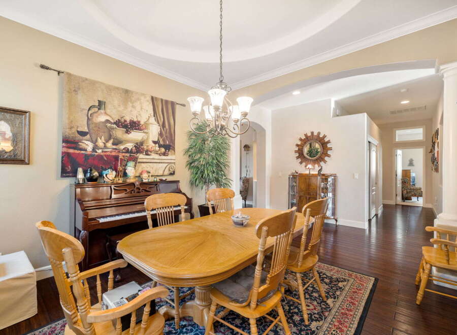 This elegant dining room features a beautiful wooden dining table with chairs, perfect for family gatherings.