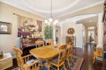 This elegant dining room features a beautiful wooden dining table with chairs, perfect for family gatherings.