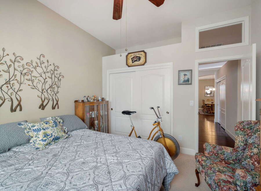 This charming bedroom features a comfortable bed adorned with decorative pillows and a stylish comforter.