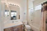 This bathroom features a spacious vanity with a tiled countertop and ample storage, perfect for organizing your essentials.