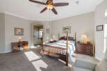 Experience luxury and comfort in this spacious master suite, featuring a grand four-poster bed and a cozy seating area.