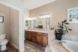 This spacious bathroom features a double vanity with ample storage and a large mirror, perfect for busy mornings.