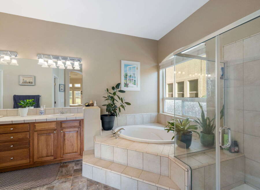 Indulge in luxury with this stunning bathroom featuring a spacious jetted tub, perfect for unwinding after a long day.