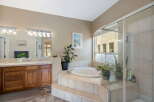 Indulge in luxury with this stunning bathroom featuring a spacious jetted tub, perfect for unwinding after a long day.