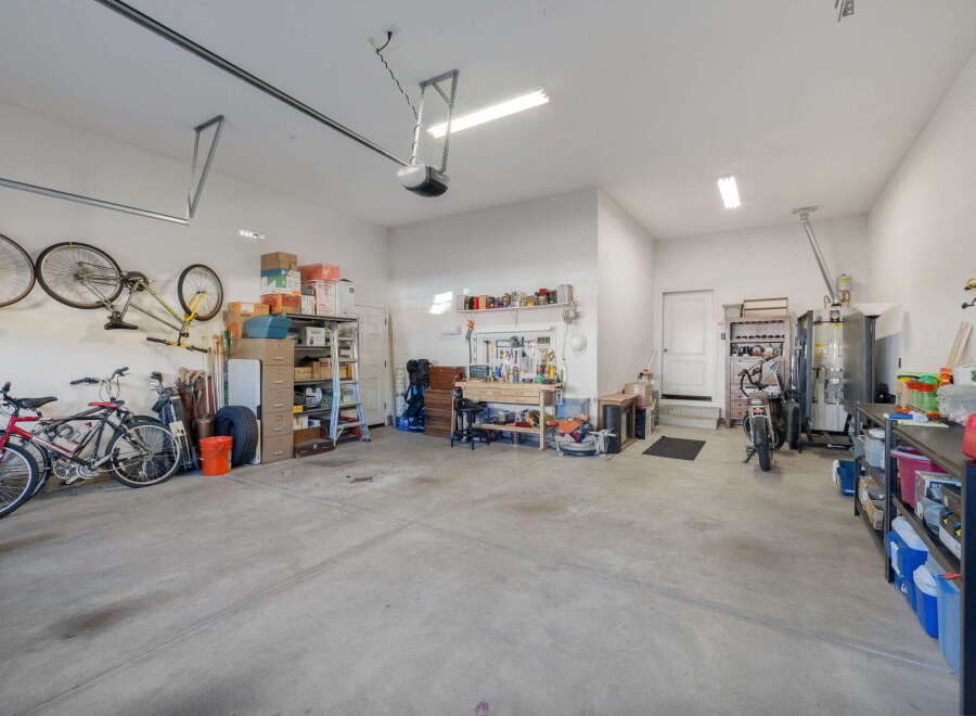 This spacious garage offers ample storage solutions with multiple shelving units, perfect for organizing tools, sports equipment, and seasonal items.