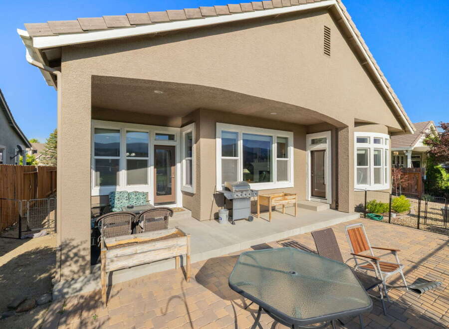 Enjoy outdoor living with this spacious patio featuring a covered area perfect for al fresco dining and entertaining.