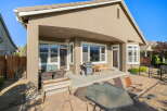 Enjoy outdoor living with this spacious patio featuring a covered area perfect for al fresco dining and entertaining.