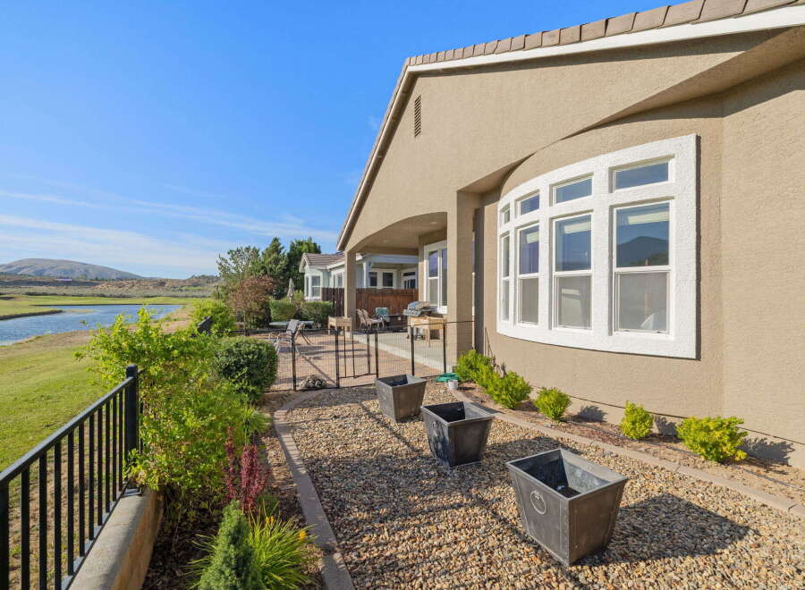 Enjoy stunning water and golf course views from this beautiful home's expansive backyard.