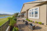 Enjoy stunning water and golf course views from this beautiful home's expansive backyard.