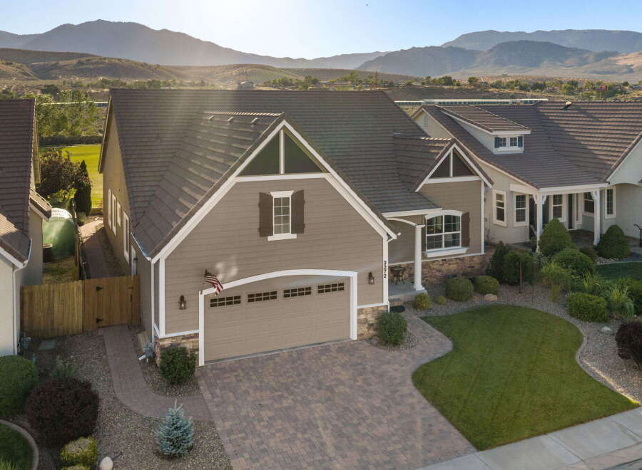 Discover this stunning home featuring a beautifully paved driveway leading to a spacious two-car garage.