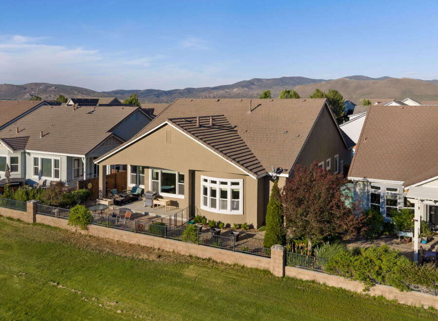 Discover this charming home featuring a spacious backyard patio perfect for entertaining, complete with comfortable seating and a grill.