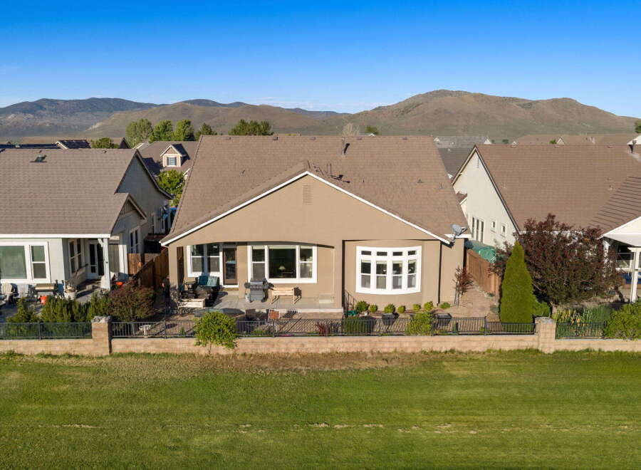 Discover this charming home featuring a spacious backyard perfect for entertaining, complete with a patio and grill area.