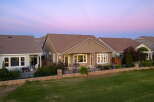 This stunning home features a spacious backyard perfect for entertaining, complete with a patio area and a grill.