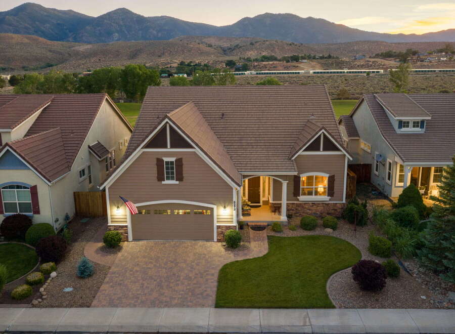 Discover this stunning home nestled against a backdrop of majestic mountains.