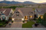 Discover this stunning home nestled against a backdrop of majestic mountains.