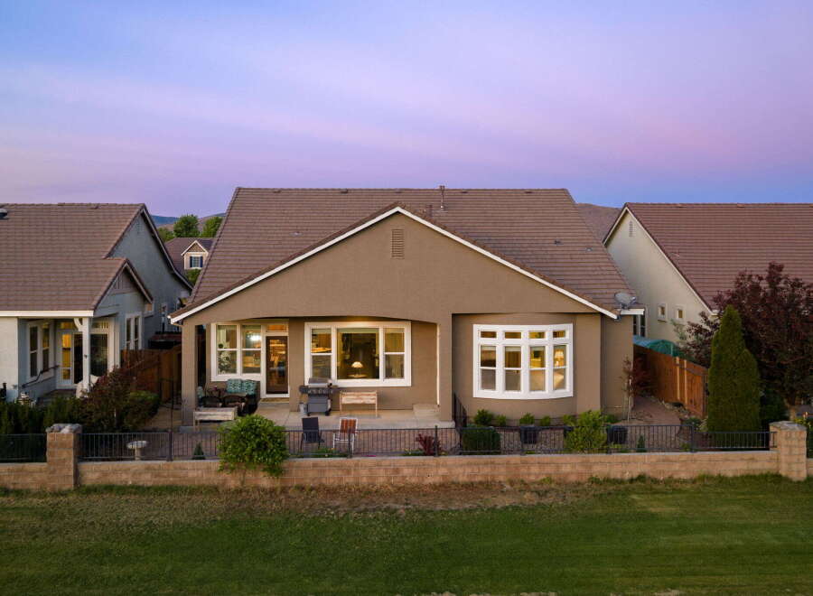 This charming home features a spacious backyard patio, perfect for entertaining guests or enjoying a quiet evening outdoors.