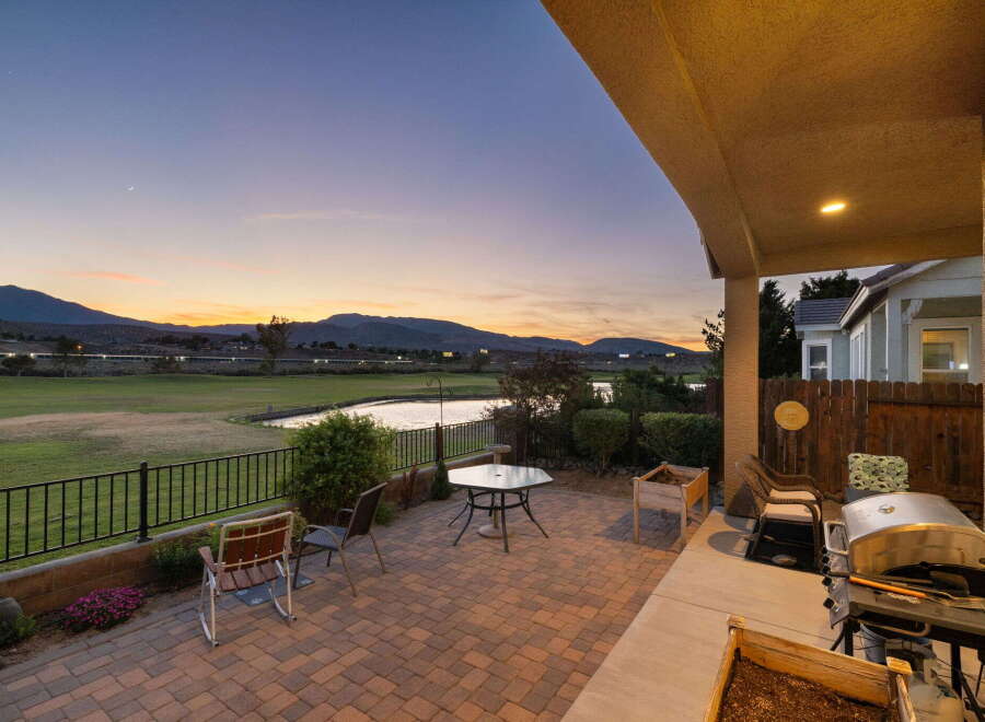 Enjoy breathtaking sunset views from this stunning patio, complete with a built-in grill and ample seating.