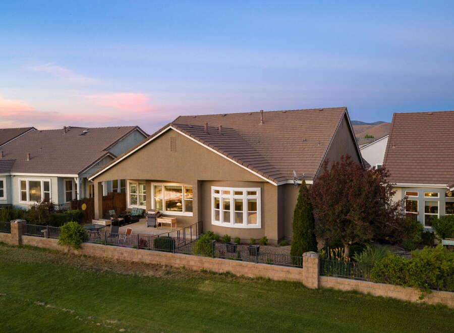 Discover this stunning home featuring a spacious backyard patio perfect for entertaining, complete with outdoor seating and a grill.