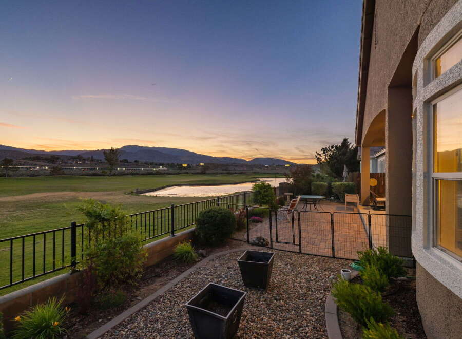 Enjoy breathtaking sunset views over the golf course and a serene lake from this stunning property.