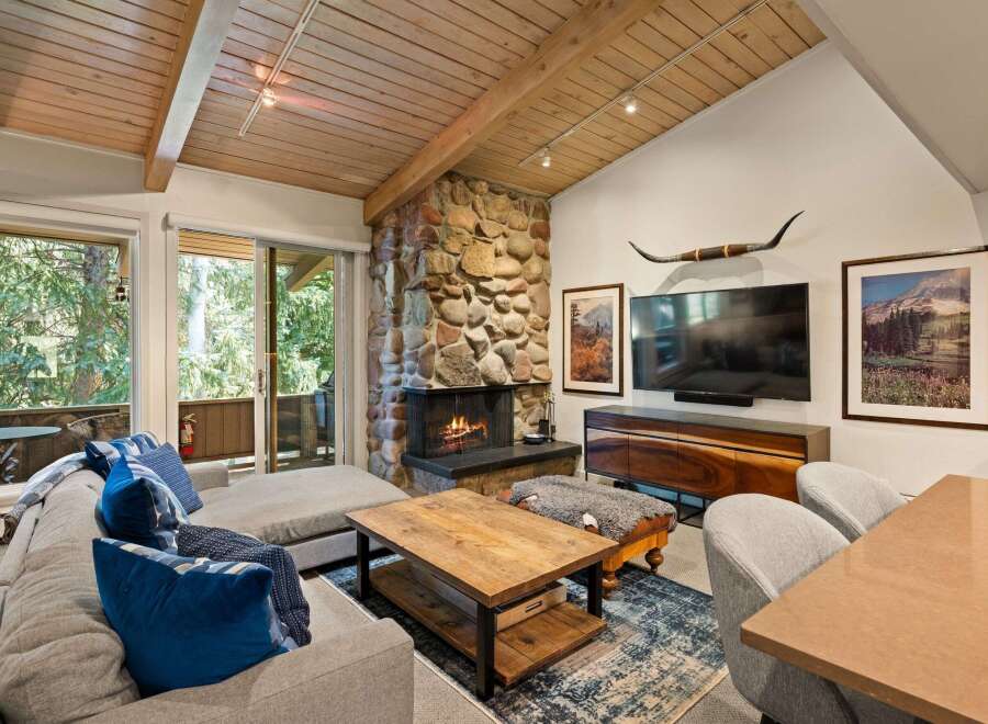 Experience rustic charm in this inviting living room, featuring a magnificent stone fireplace as the centerpiece.