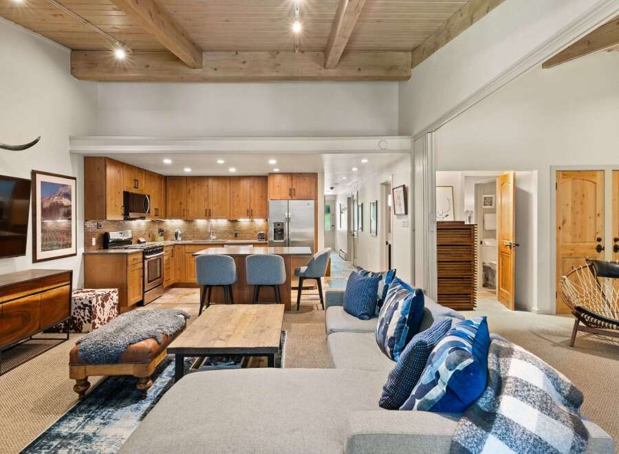 Experience modern mountain living in this stunning open-concept space, featuring a gourmet kitchen with custom wood cabinetry and a spacious living area perfect for entertaining.