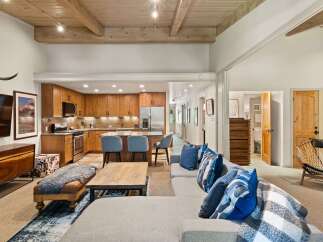 Experience modern mountain living in this stunning open-concept space, featuring a gourmet kitchen with custom wood cabinetry and a spacious living area perfect for entertaining.