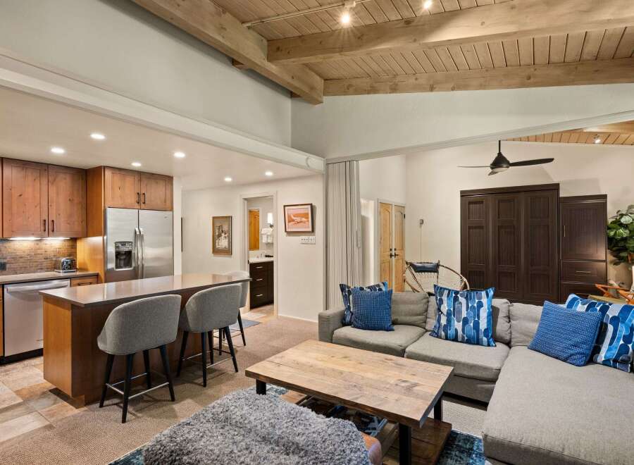 Experience modern living in this open-concept space featuring a gourmet kitchen with rich wood cabinetry and a large island perfect for entertaining.