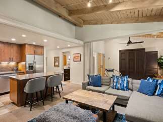 Experience modern living in this open-concept space featuring a gourmet kitchen with rich wood cabinetry and a large island perfect for entertaining.