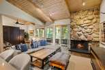 Cozy living room featuring a large stone fireplace and a comfortable sectional sofa, perfect for relaxing evenings.