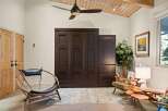 Discover this inviting living space featuring a large, dark wood murphy bed system, perfect for maximizing room utility.