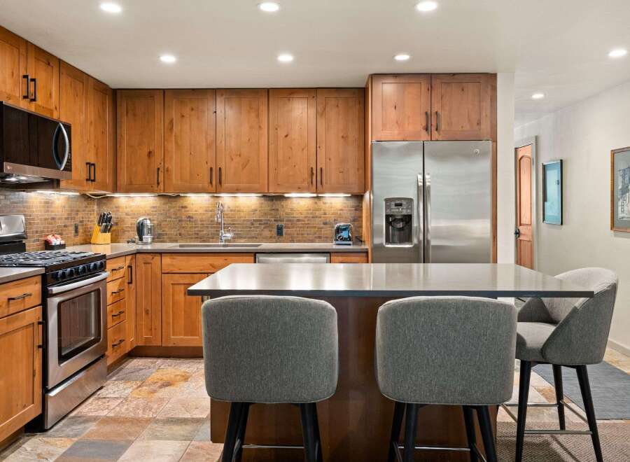 Experience culinary excellence in this beautifully appointed kitchen, featuring custom wood cabinetry and sleek, modern countertops.