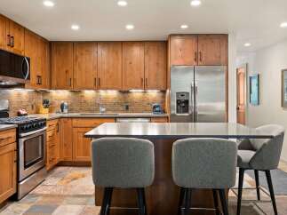 Experience culinary excellence in this beautifully appointed kitchen, featuring custom wood cabinetry and sleek, modern countertops.