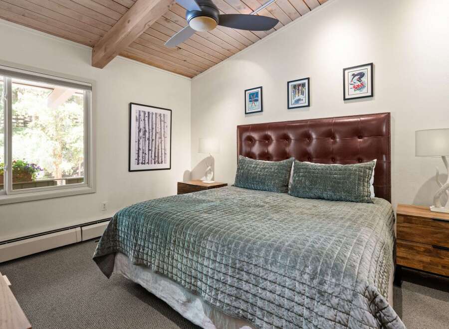 Experience ultimate comfort in this inviting bedroom, featuring a luxurious tufted leather headboard and a plush, quilted bedspread.