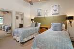 This inviting bedroom features two comfortable twin beds, perfect for accommodating guests or family.