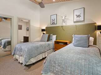 This inviting bedroom features two comfortable twin beds, perfect for accommodating guests or family.