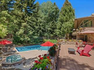 Escape to this stunning mountain retreat featuring a sparkling swimming pool and a relaxing hot tub, perfect for unwinding after a day of adventure.